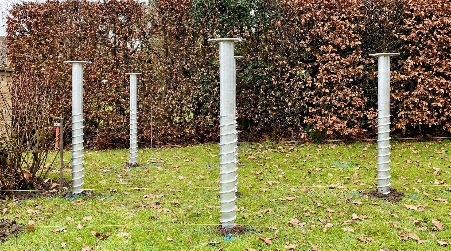 Ground screw foundations installed in a garden